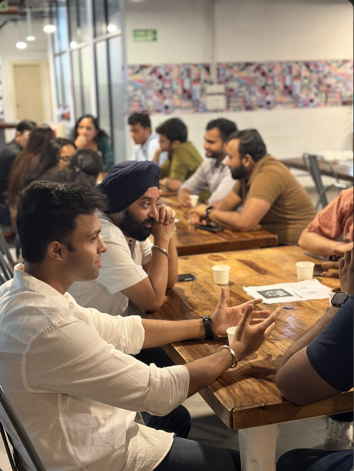 Attendees in conversation around a table during speed networking
